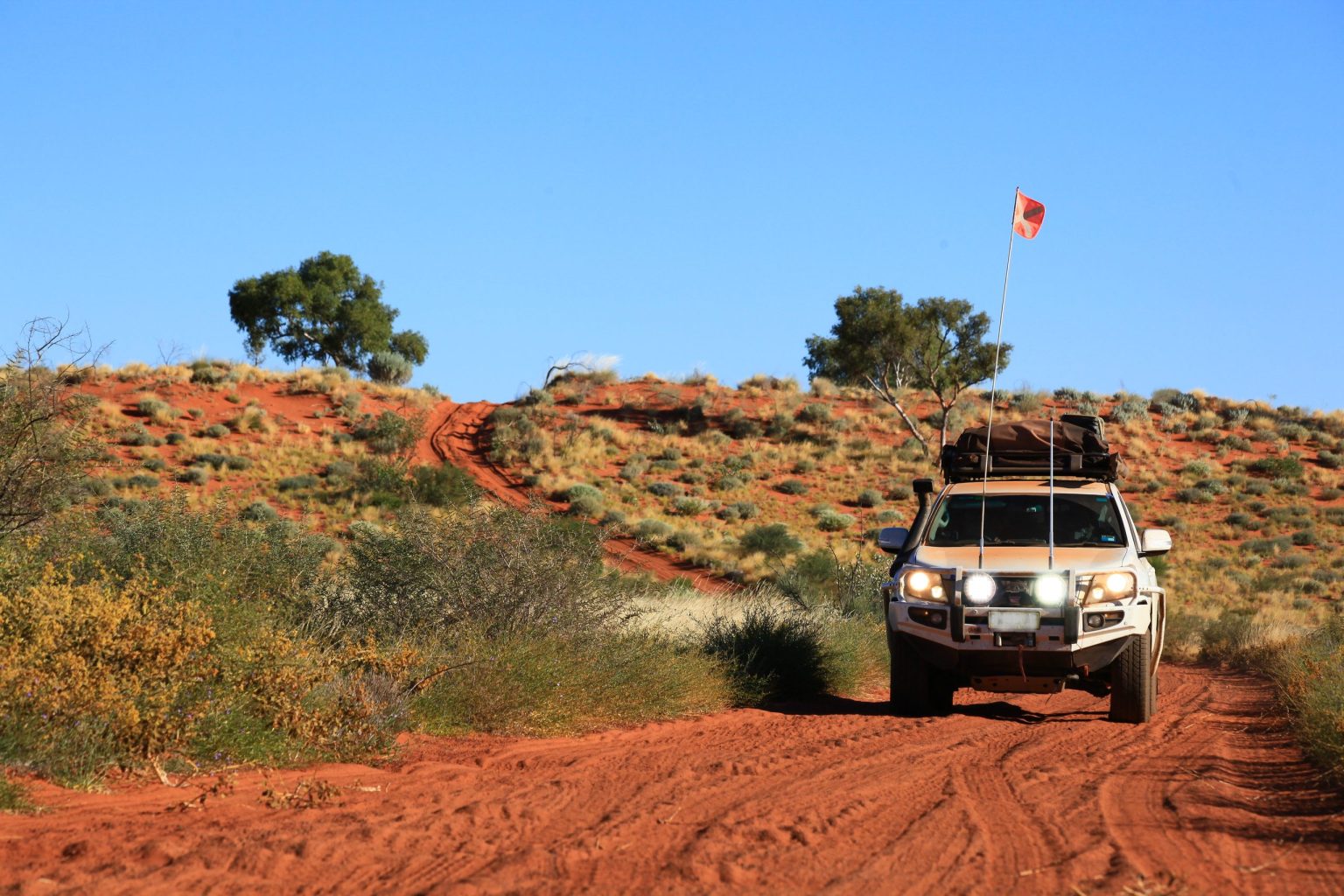 4x4 cresting a red sand dune on the Canning Stock Route