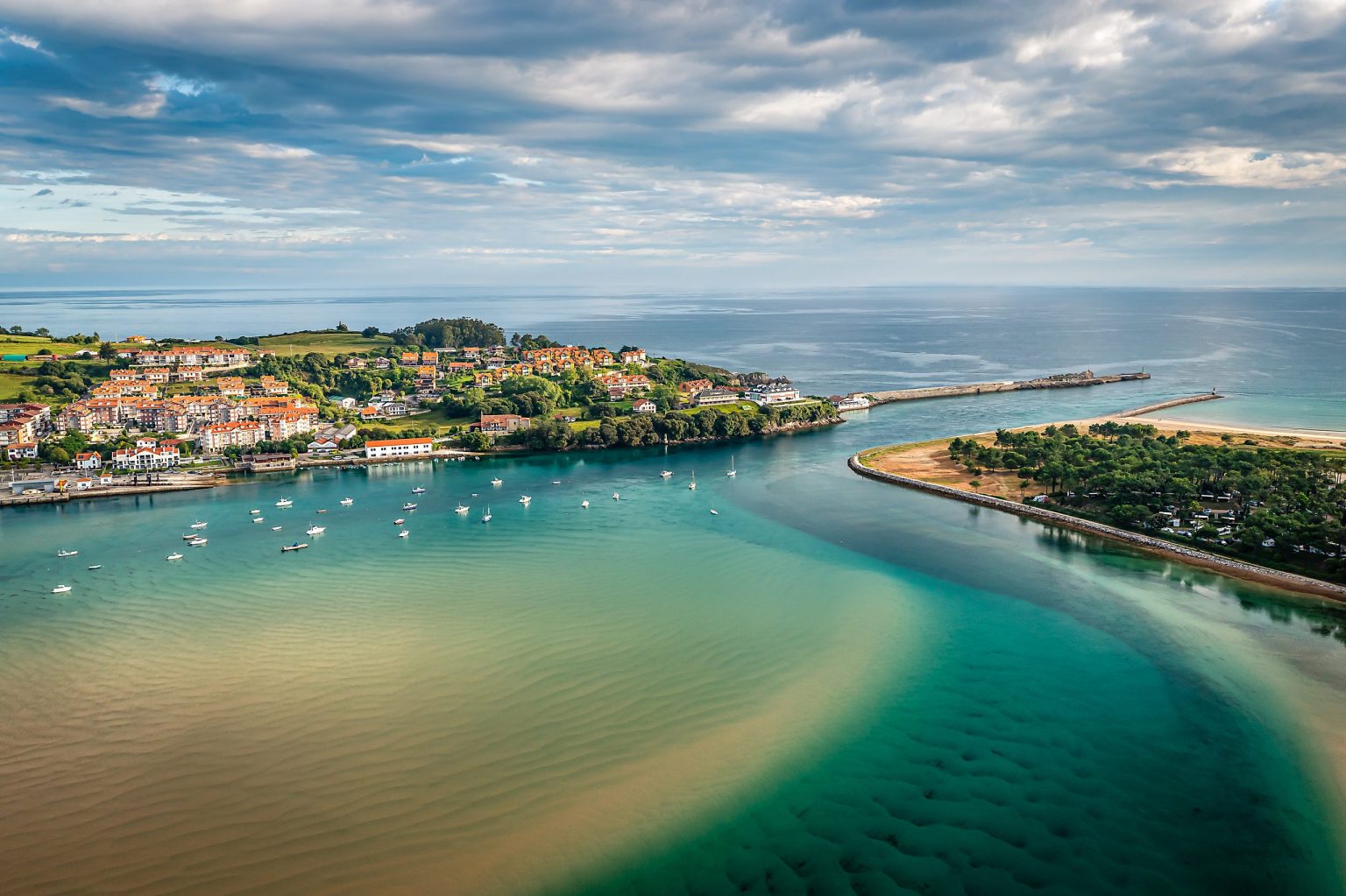 Aerial view of an estuary and fishing town on the Cantabrian coast