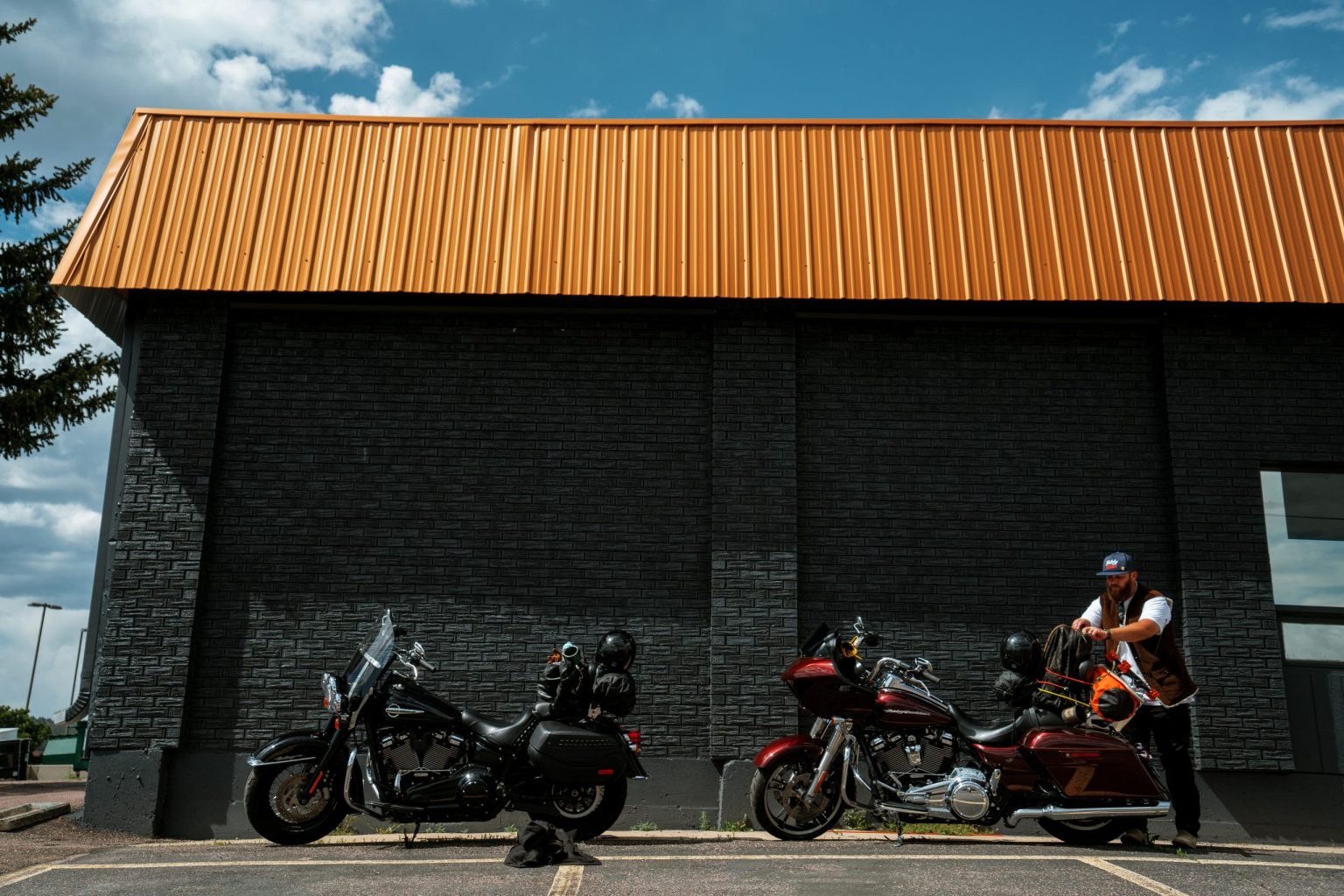 Riders with Harley-Davidson motorcycles at a roadside stop