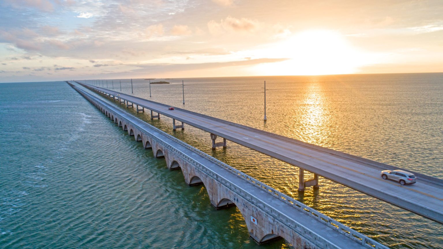 Car crossing the Seven Mile Bridge at sunset in the Florida Keys