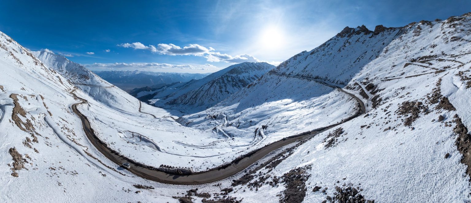 Mountain road curving through snow in the Himalaya