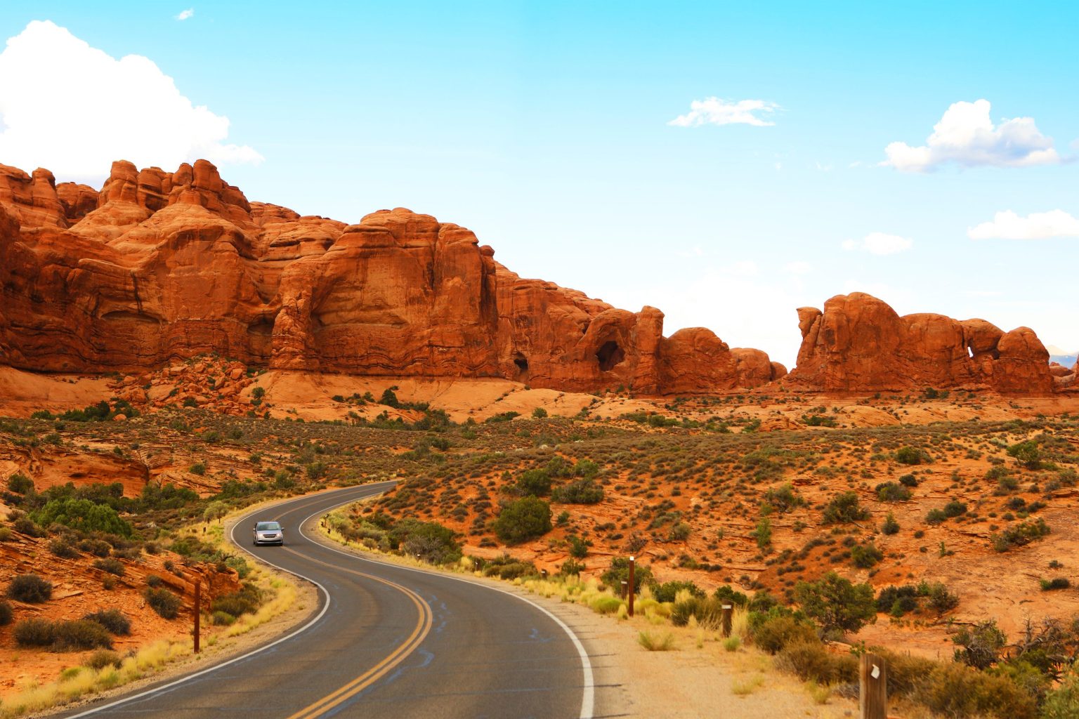 Scenic drive winding through red rock formations in Arches National Park, Utah