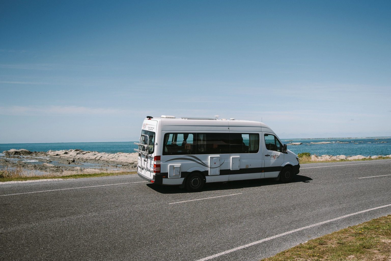 Campervan on a coastal road beside the sea, Kaikoura, New Zealand's South Island