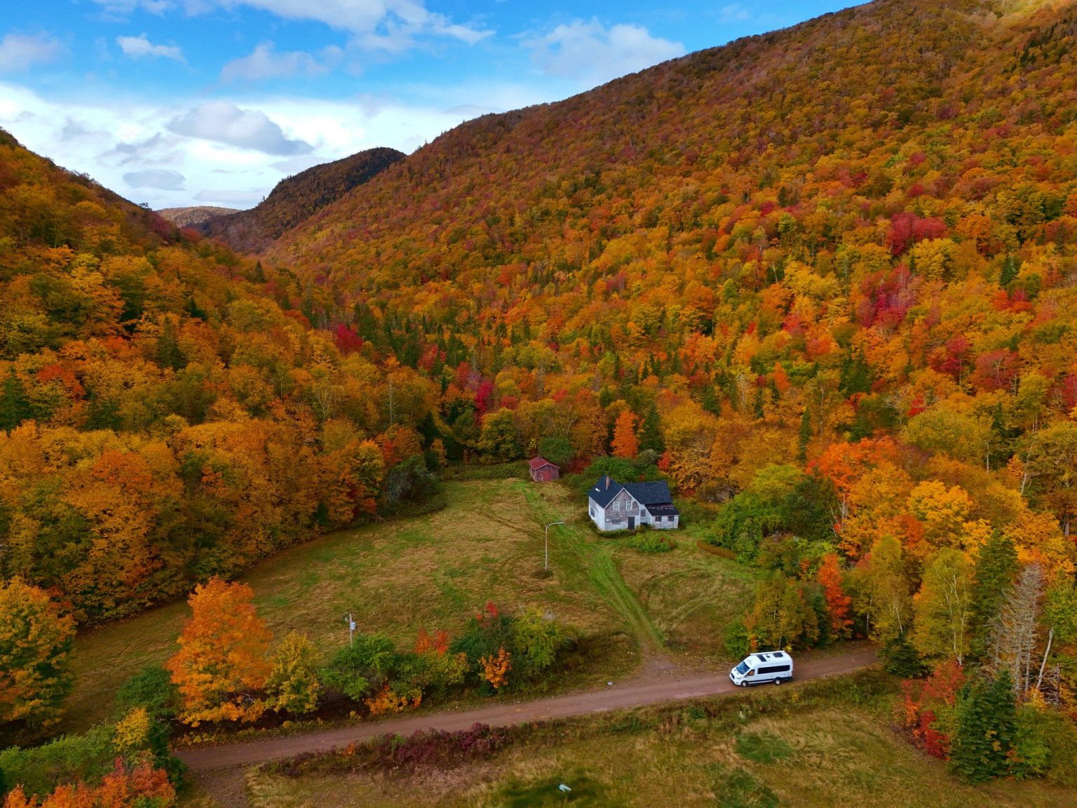 Aerial view of autumn forest around a valley with a motorhome, Nova Scotia, Canada