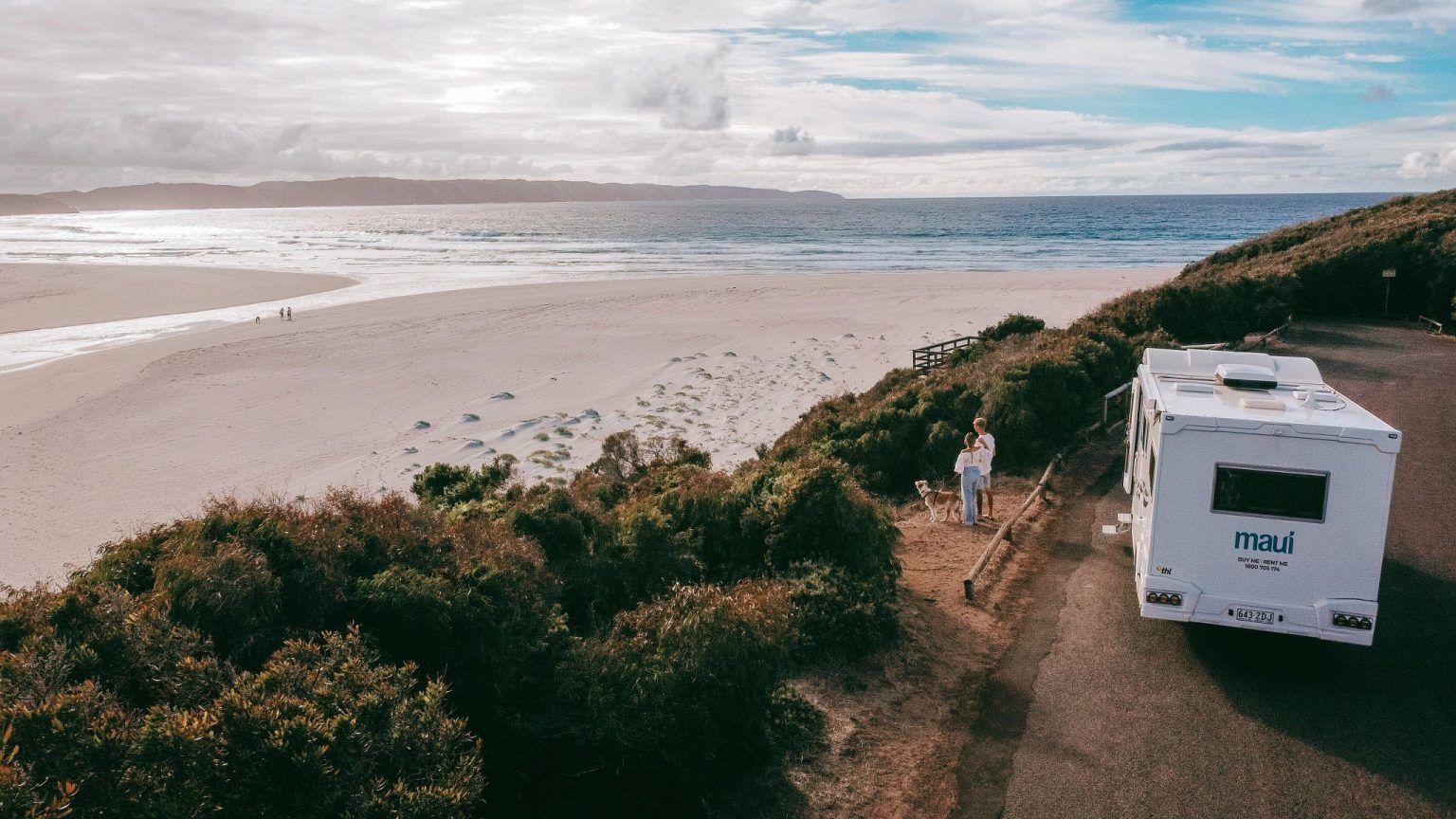 Couple walking towards a motorhome parked on a coastal headland, Perth, Western Australia