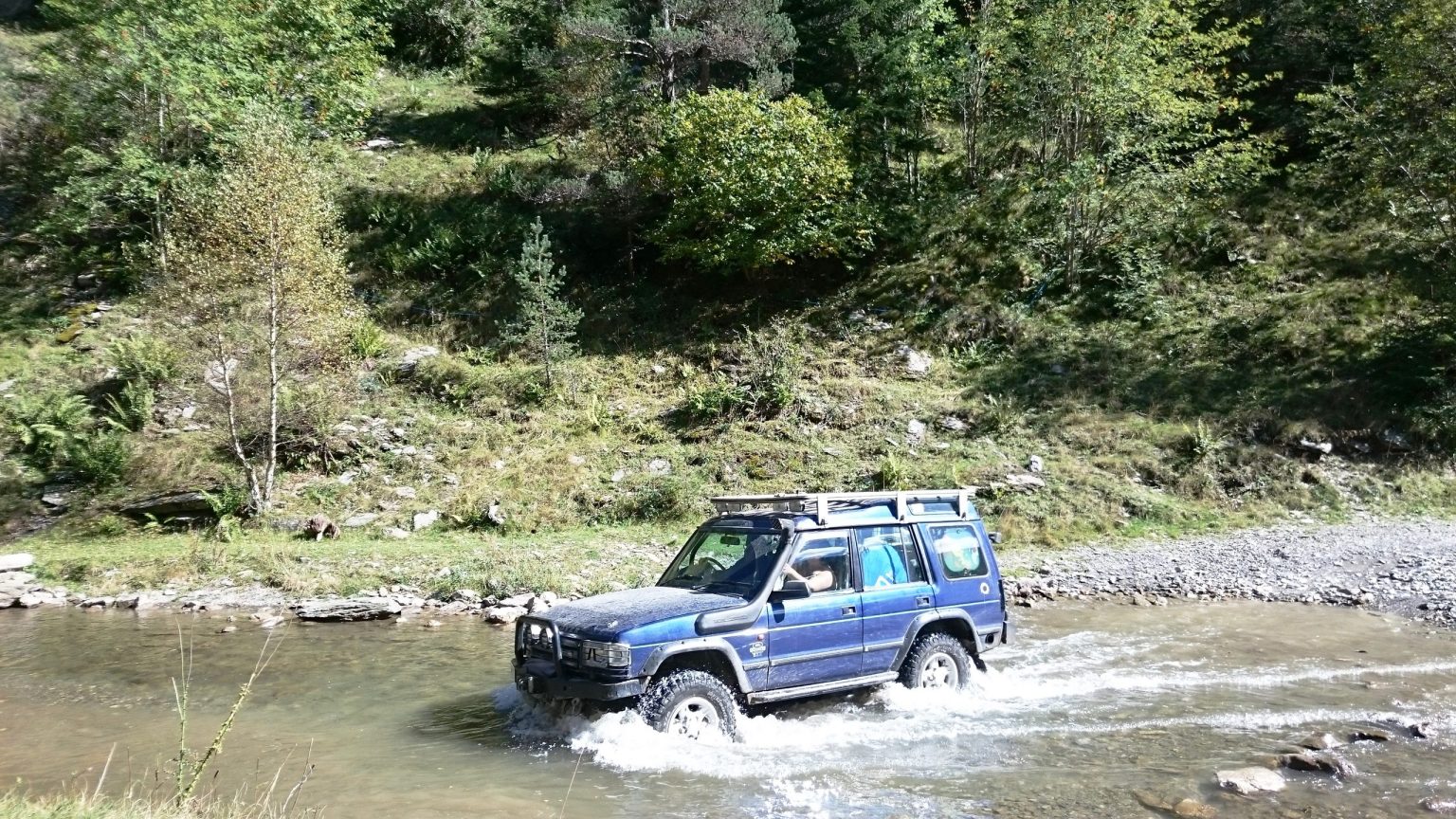 4x4 fording a mountain stream in the Pyrenees