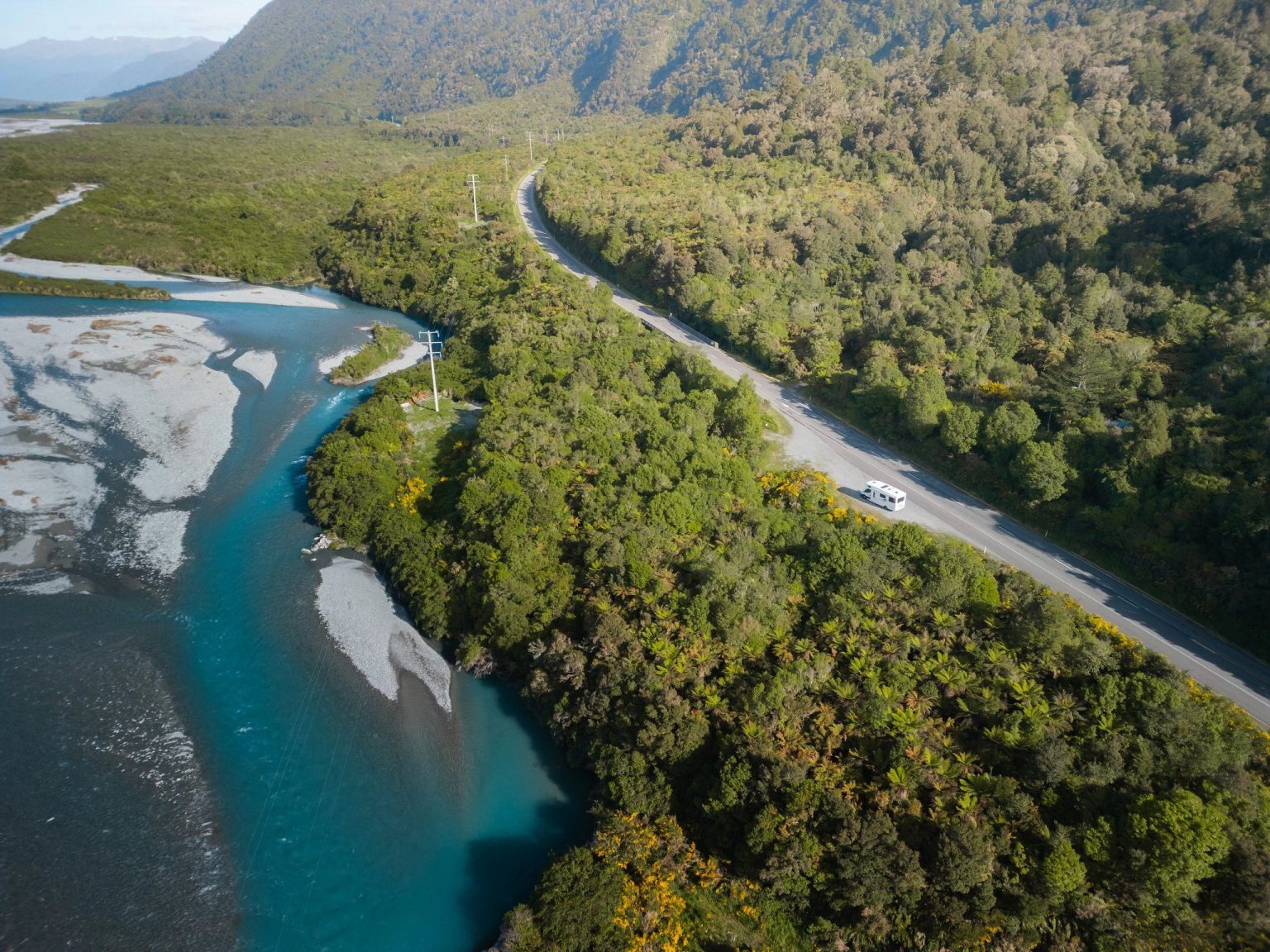 Aerial view of a braided river beside a forested road, Arthur's Pass National Park, New Zealand's South Island