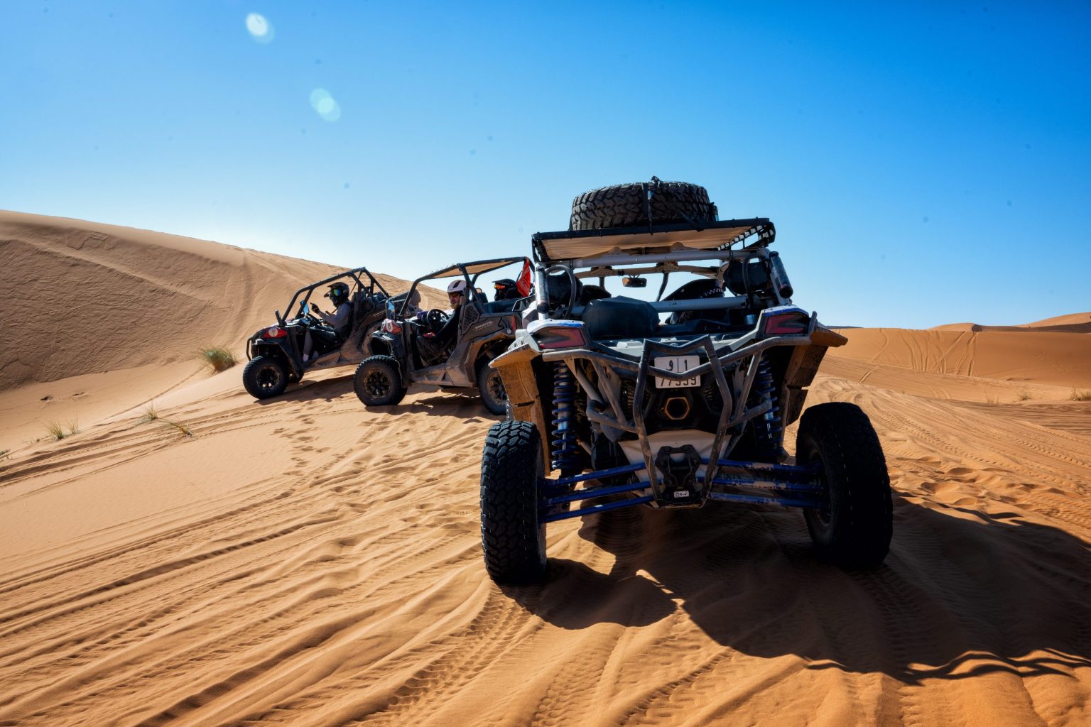 Can-Am buggy powering over a Sahara dune