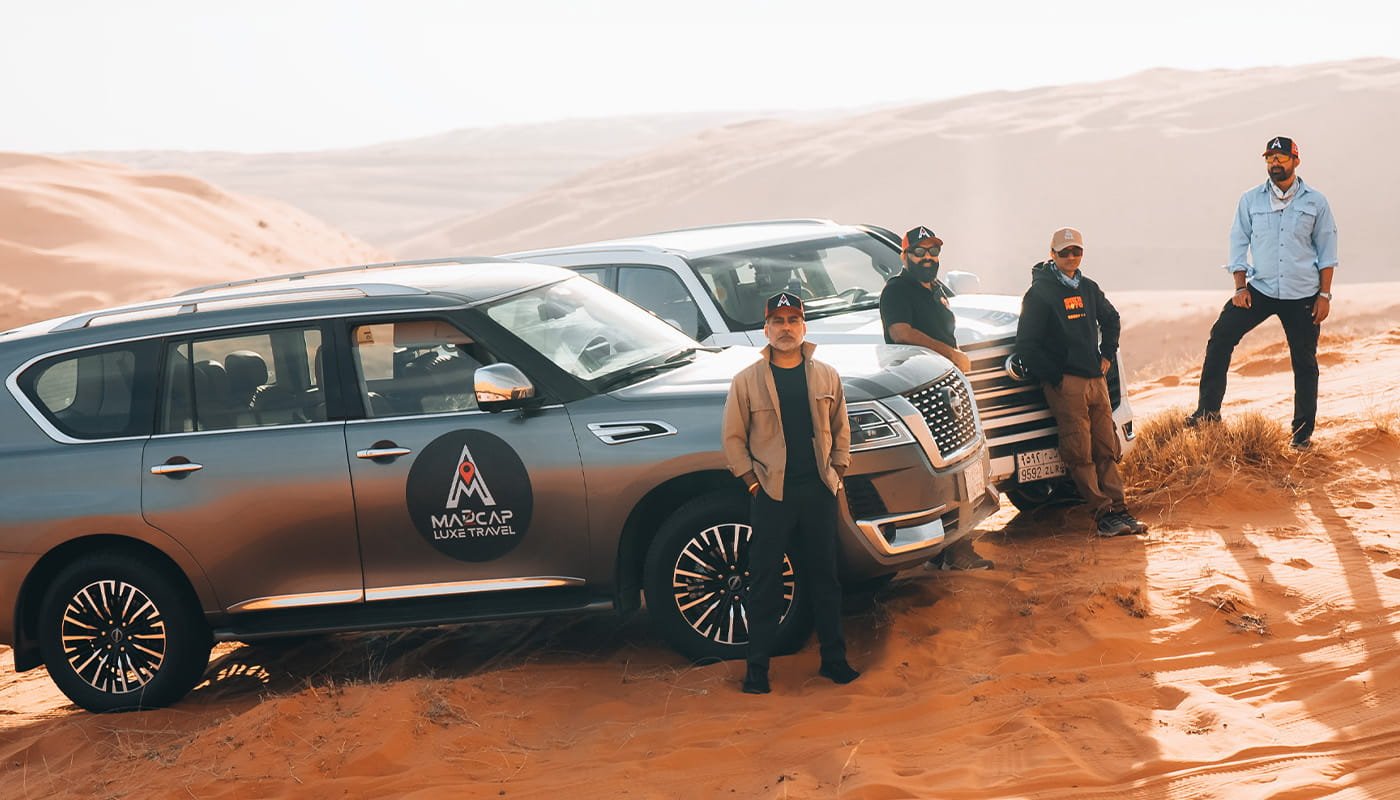 Nissan Patrol convoy and travellers on the desert sands of Saudi Arabia