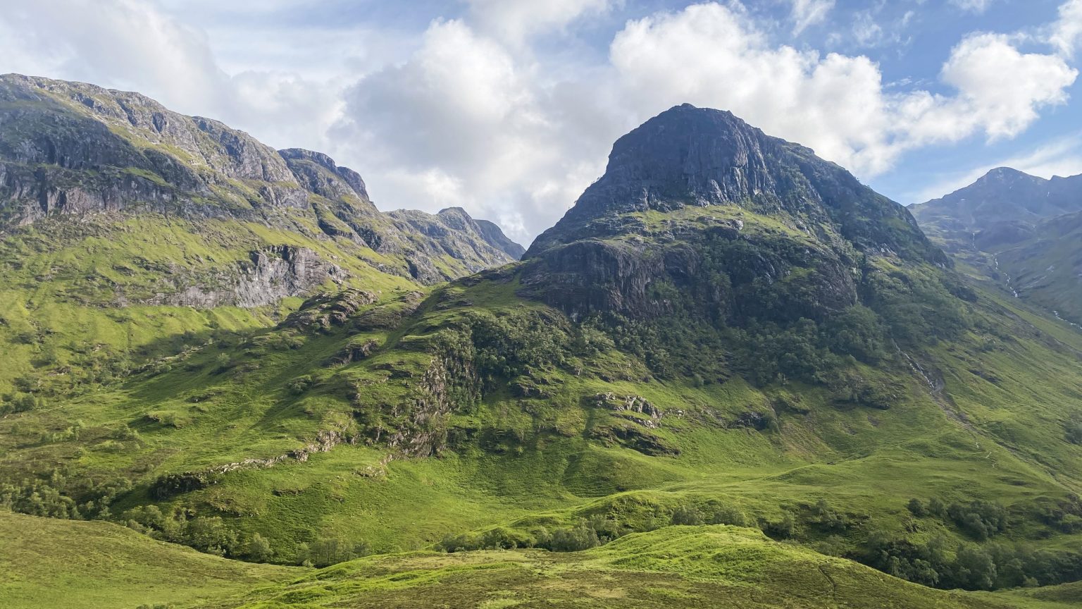 Green Highland peaks above a glen in Scotland