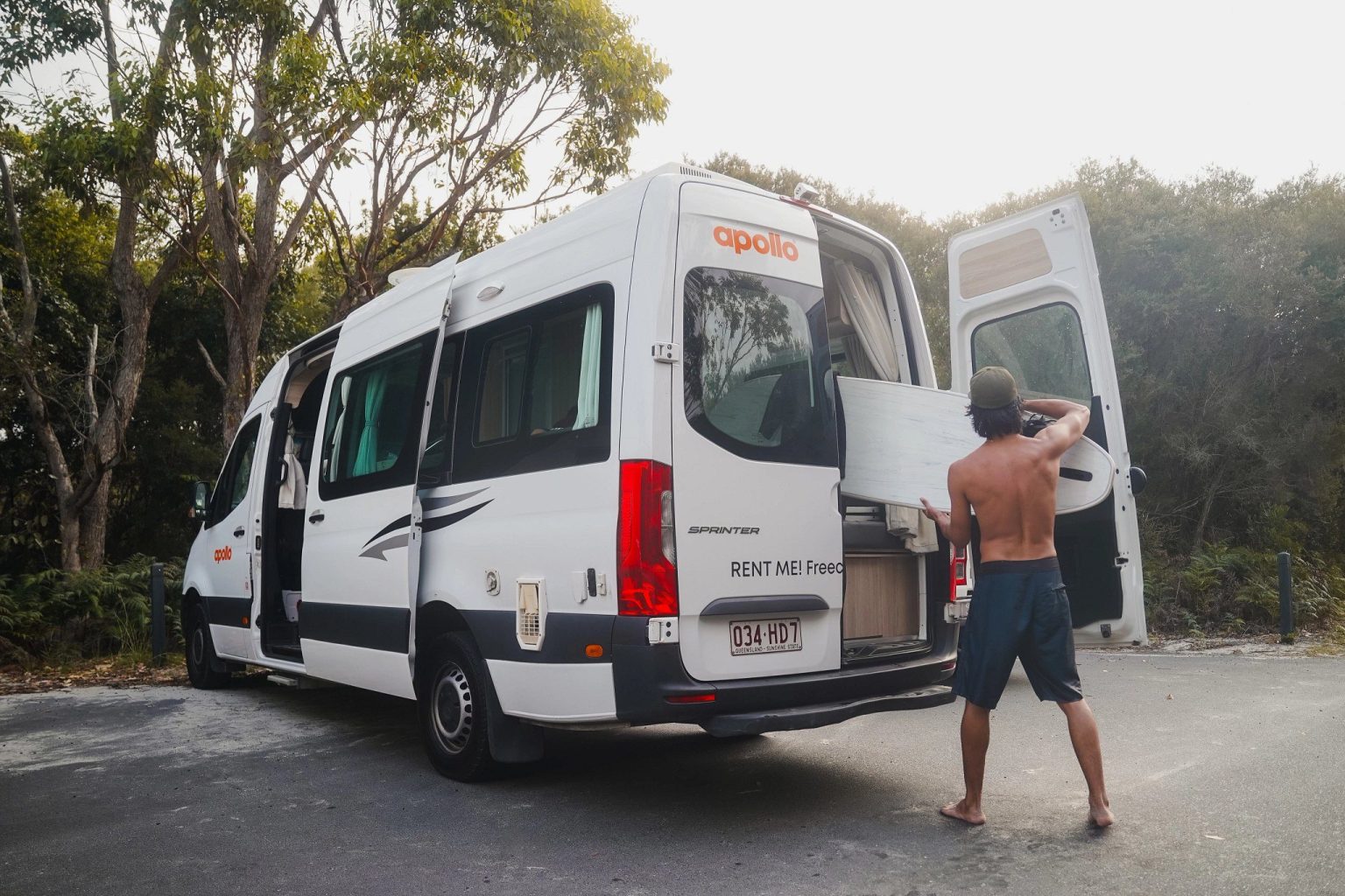 Man loading the rear of a campervan in a misty forest, Jervis Bay, New South Wales